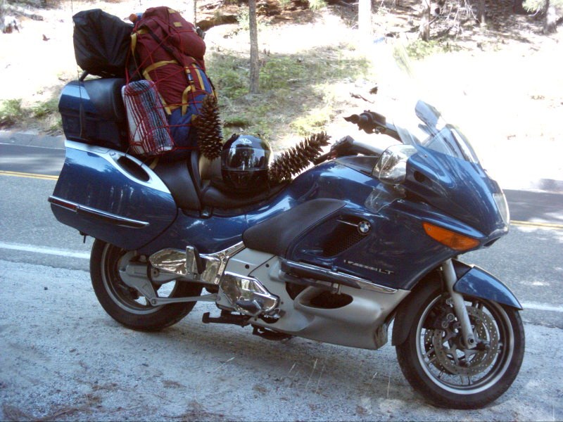Grace parked roadside with camping gear and a large sugar pine cone on the seat near Yosemite